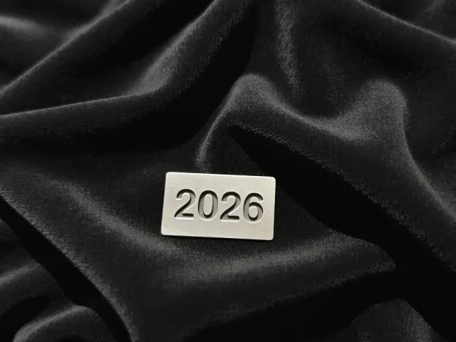 Metallic 2026 label on smooth black velvet fabric