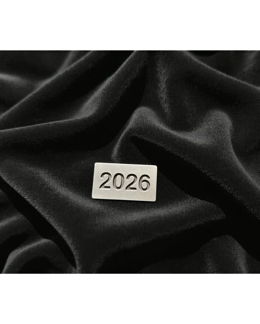 Metallic 2026 label on smooth black velvet fabric