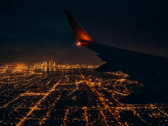 Aerial night skyline seen from airplane window