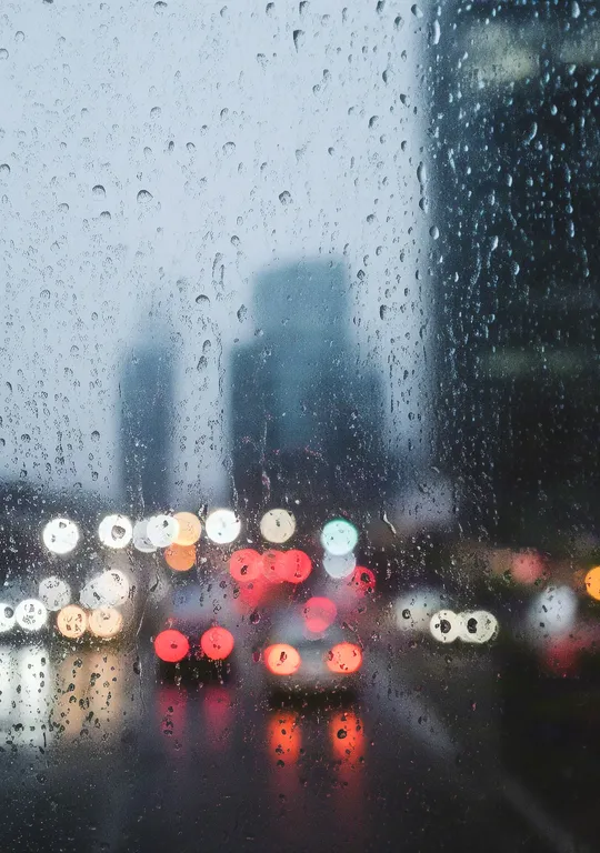 City lights glowing through rainy glass
