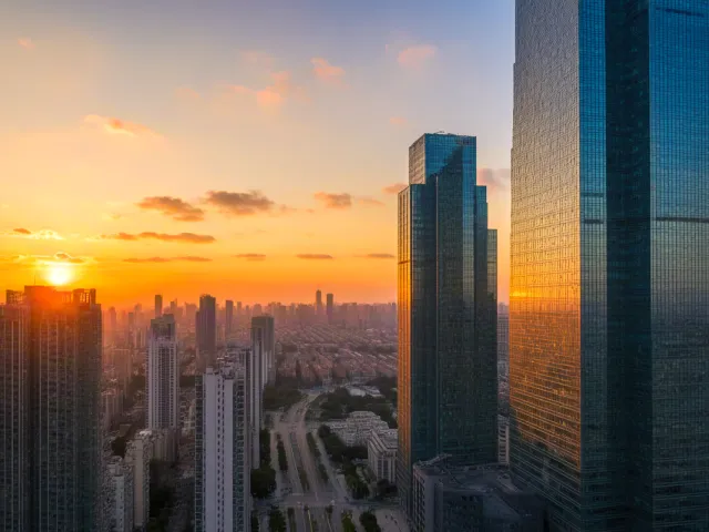 Tall buildings glowing in early morning sunlight