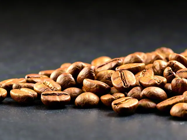 Roasted coffee beans on black surface