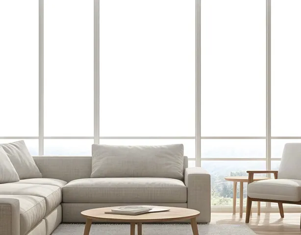 Minimalist living room in soft beige tones with daylight through wide windows.
