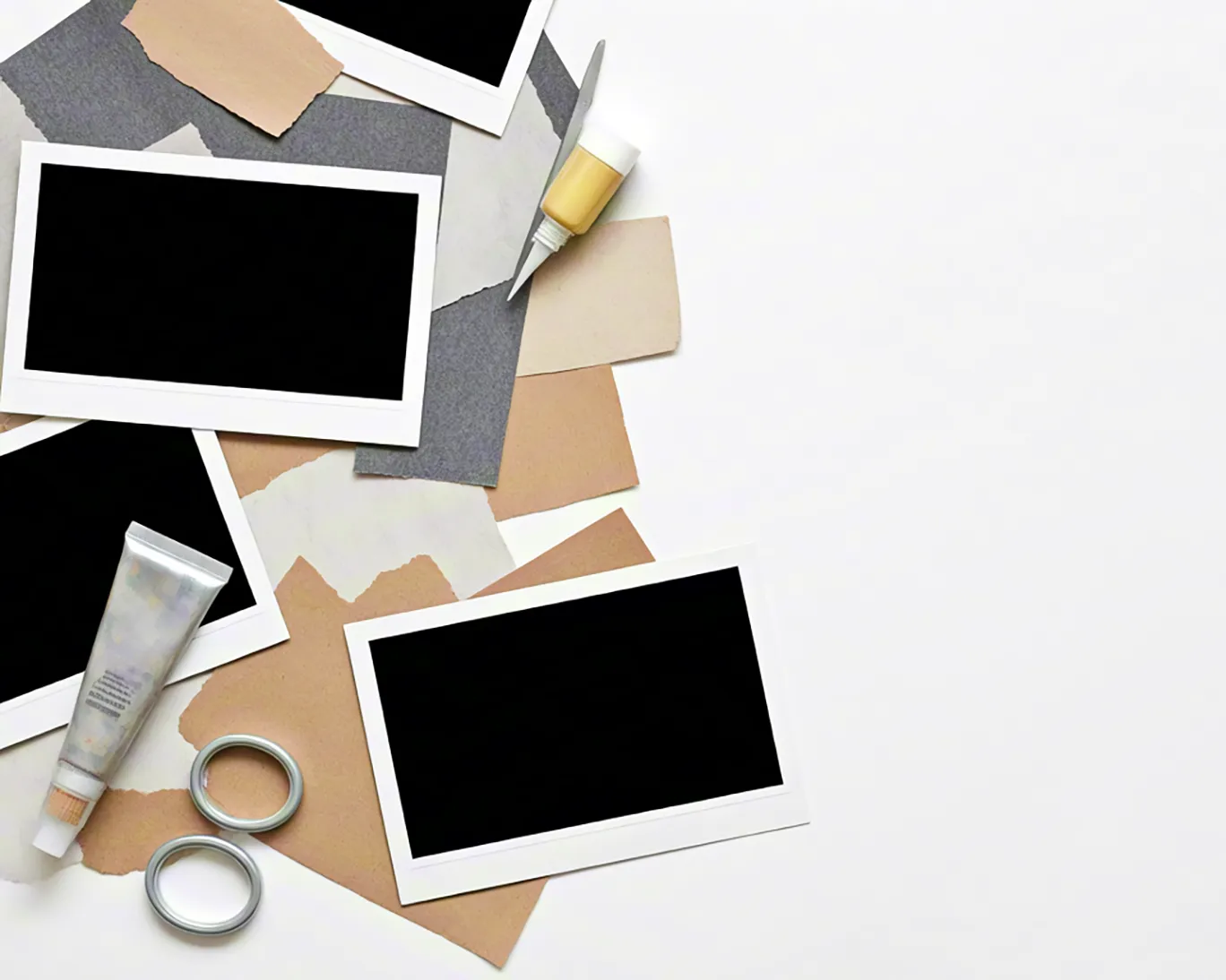 collage craft desk with blank photo frames and stationery