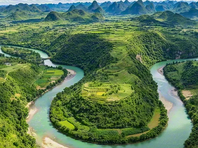 Beautiful green landscape with winding river and cloudy blue sky.