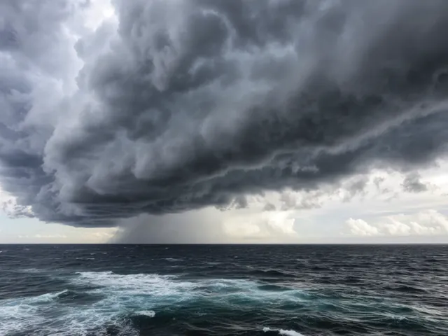 Threatening clouds covering the sky above churning blue-gray sea.