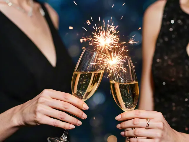 people holding sparklers and champagne in festive evening setting