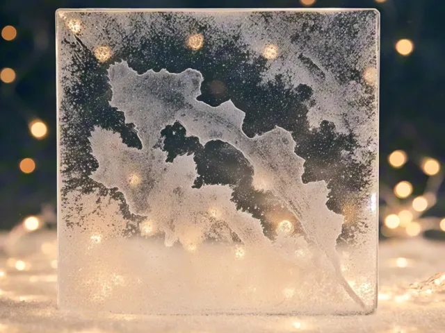 frozen glass block with snowflake patterns and glowing winter light