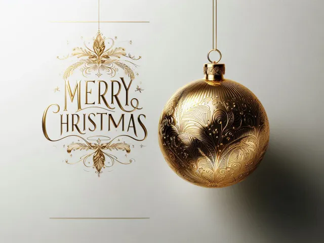 Elegant gold bauble hanging beside Merry Christmas handwritten text