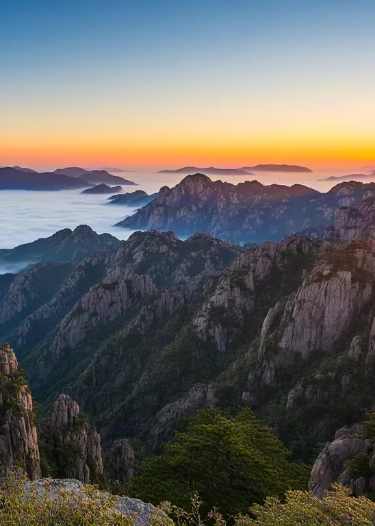 Golden sunrise in misty mountain landscape