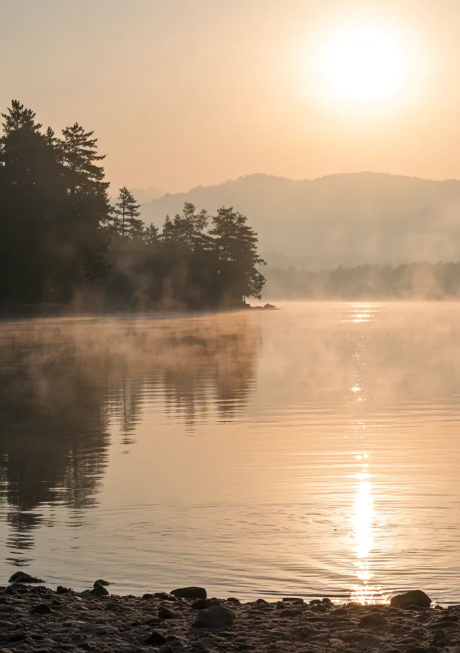 Golden sunrise over misty lake – peaceful morning landscape