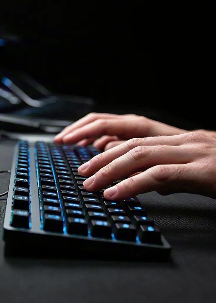 Hands typing on keyboard — technology workspace