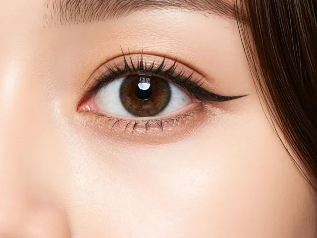 close-up portrait of a woman’s eye in soft studio lighting