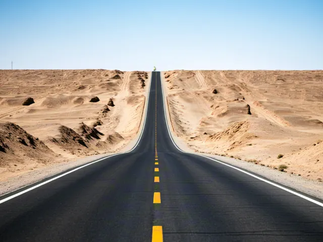 Straight highway through desert landscape