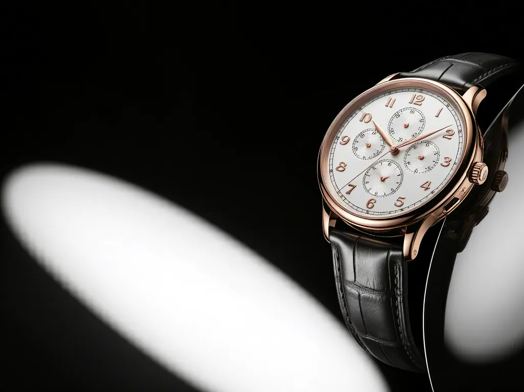 Close-up of an elegant wristwatch with leather strap and gold casing on black reflective background, symbolizing luxury and precision