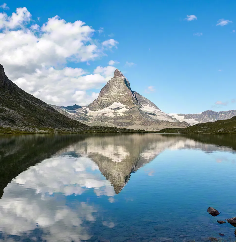Majestic mountain peak reflected in clear alpine lake