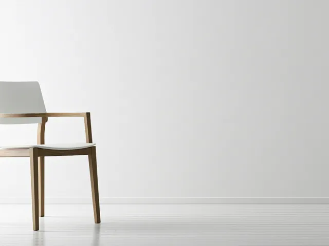Simple wooden chair against clean white wall