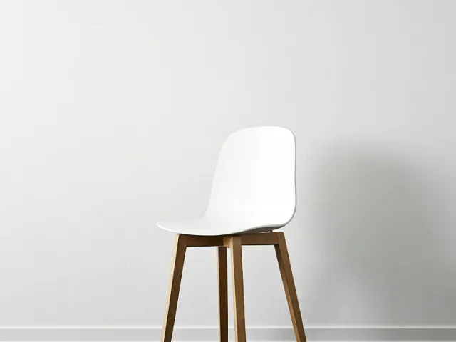 Simple white chair in clean white room
