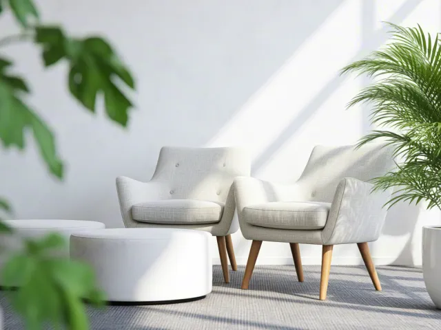 White armchairs and green plants in bright minimalist room.