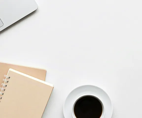 Coffee and laptop on light background creating calm work atmosphere.