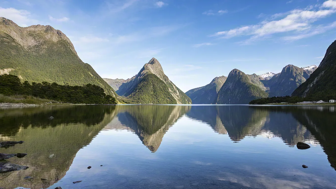 Clear lake reflecting dramatic mountain peaks