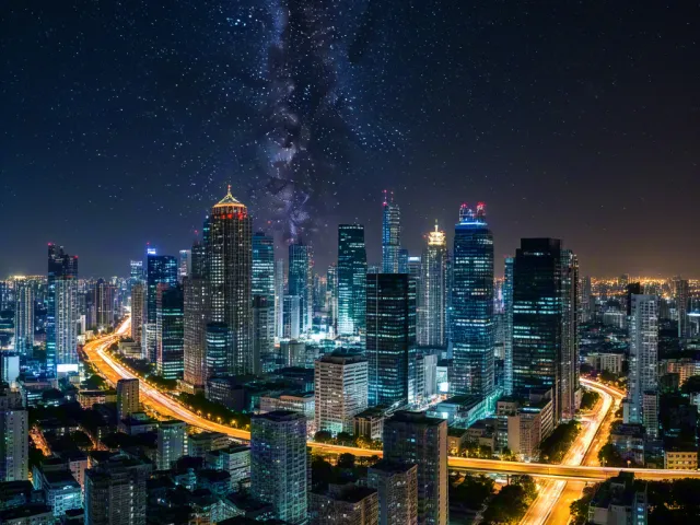City lights beneath bright starry sky