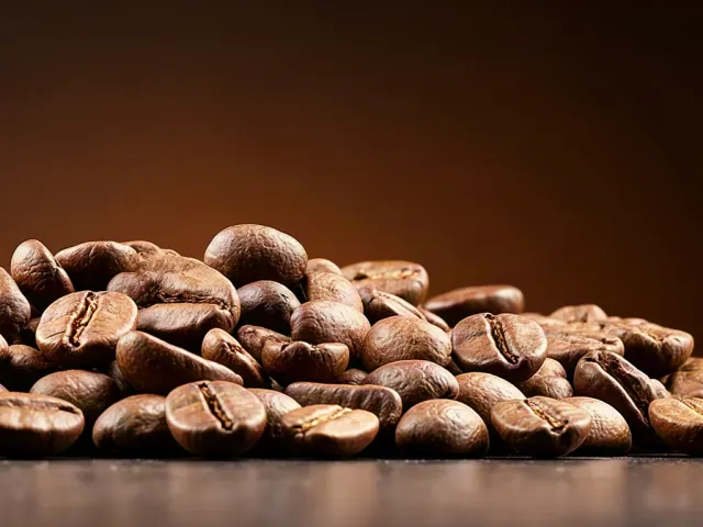 Roasted coffee beans under warm studio light