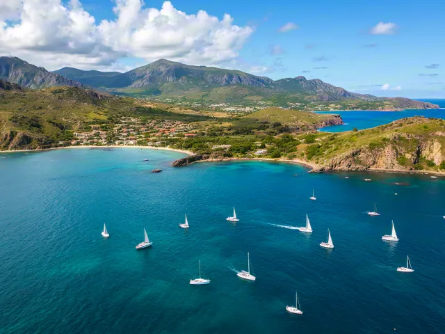 Aerial view of sailboats in turquoise coastal water