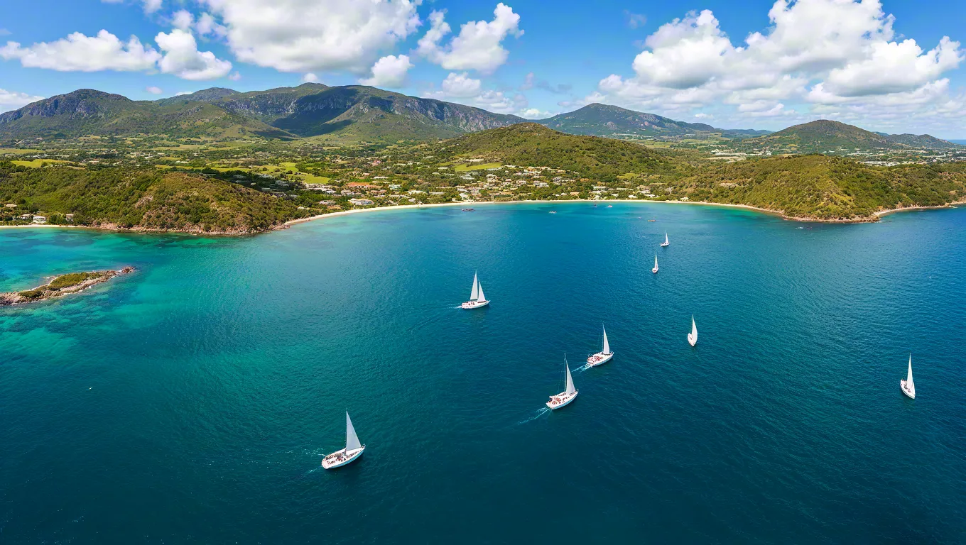 Aerial view of sailboats in turquoise tropical water