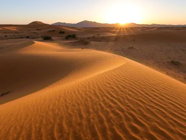 Glowing sand dunes under early morning light