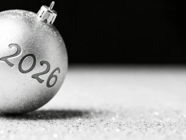 Minimal silver bauble with 2026 engraved on monochrome background