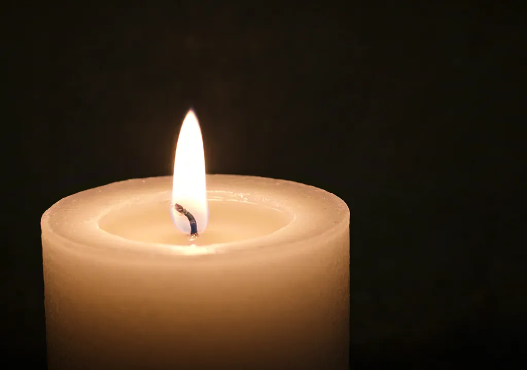 Soft glowing candle symbolizing peace