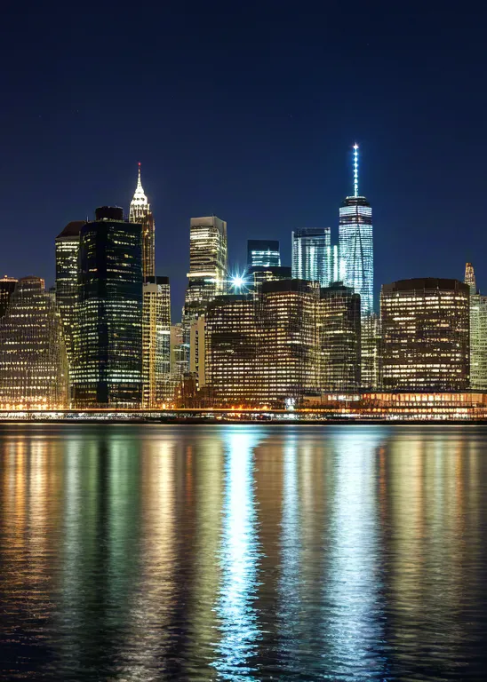 Modern city skyline at night with reflections