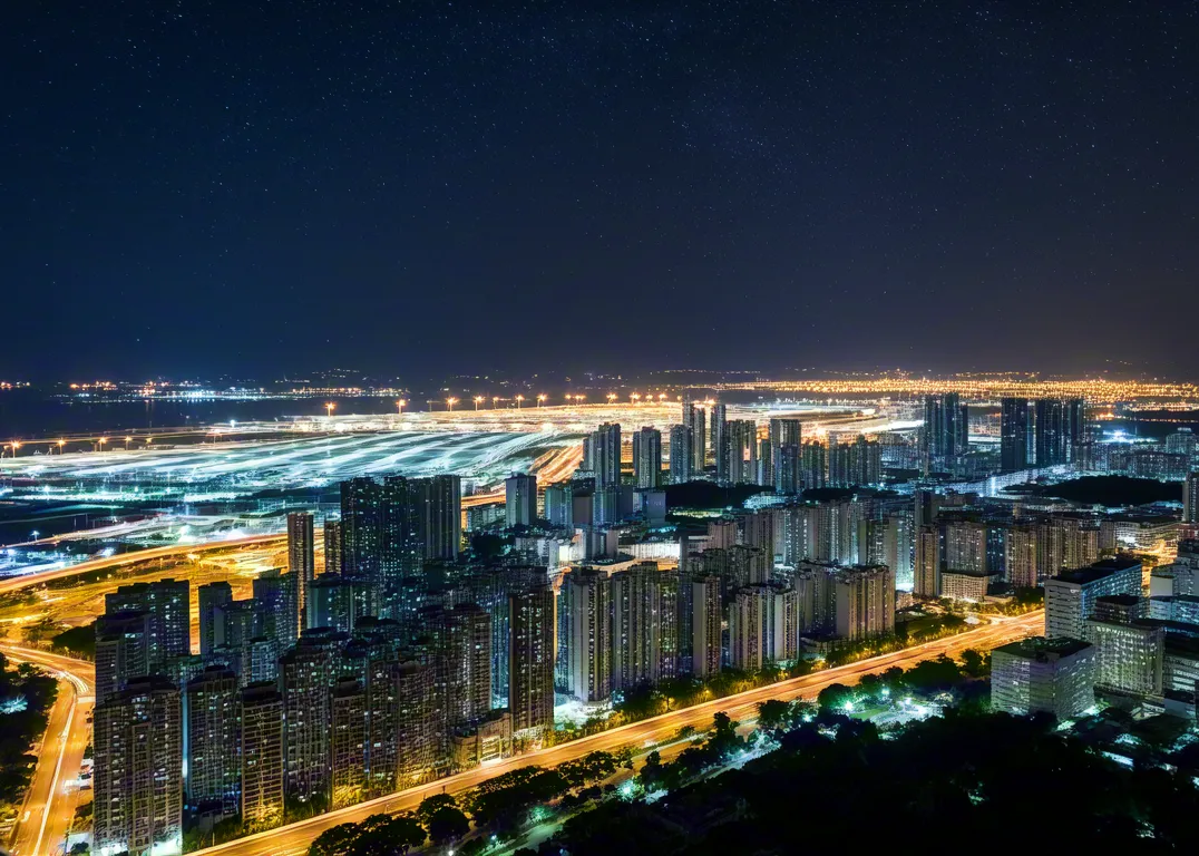Aerial night view of glowing city buildings