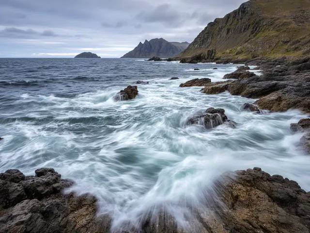Long exposure waves hitting coastal rocks