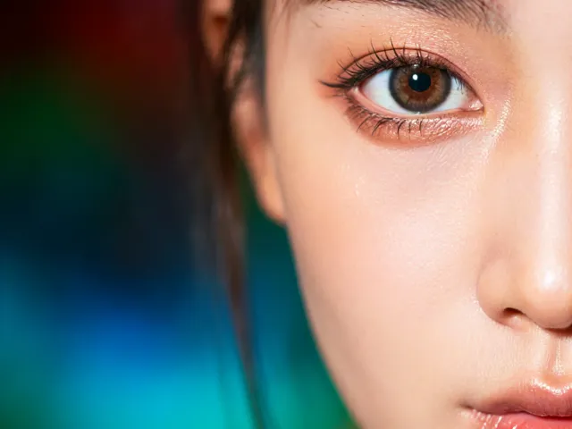 artistic close-up portrait of woman with colorful lighting