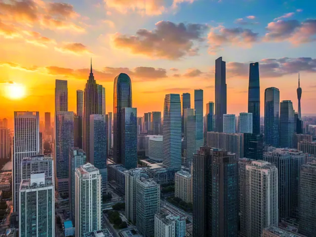 Aerial view of modern city skyline illuminated by sunset light