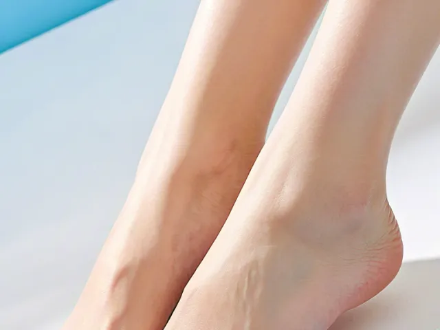 Close-up of well-groomed female feet on clean blue gradient surface