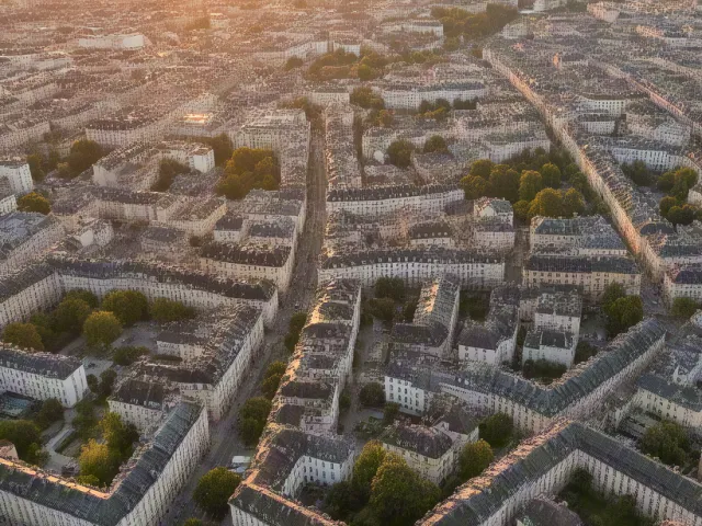 Aerial view of city at sunset with warm light